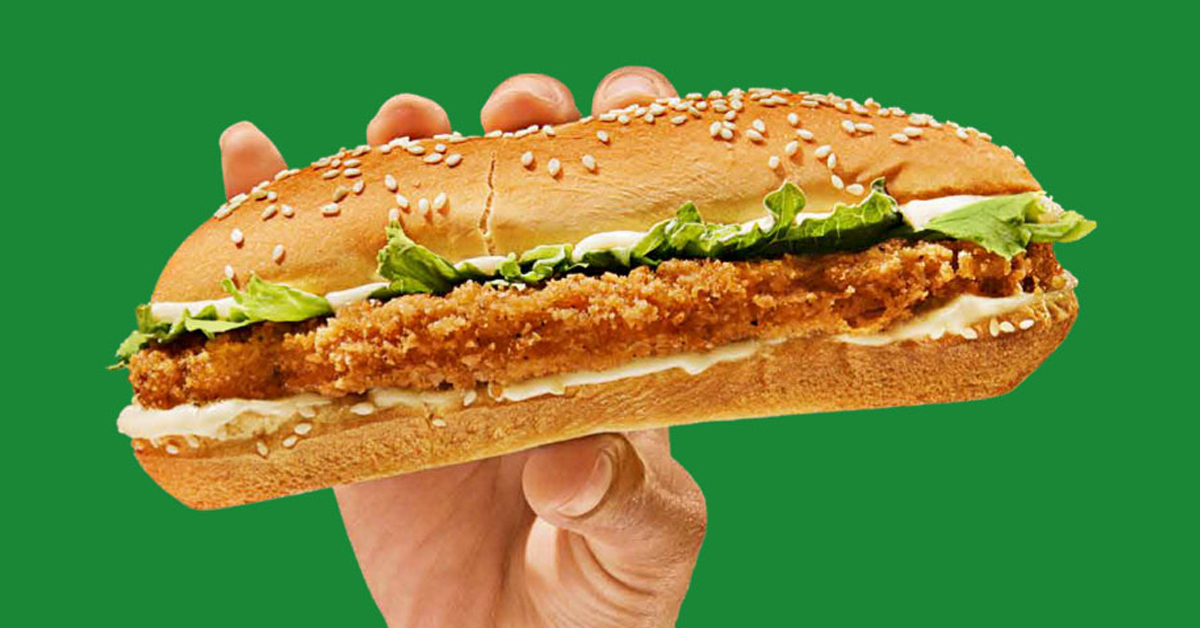 Hand holding Burger King's plant-based chicken sandwich called Impossible Original Chick'n Sandwich