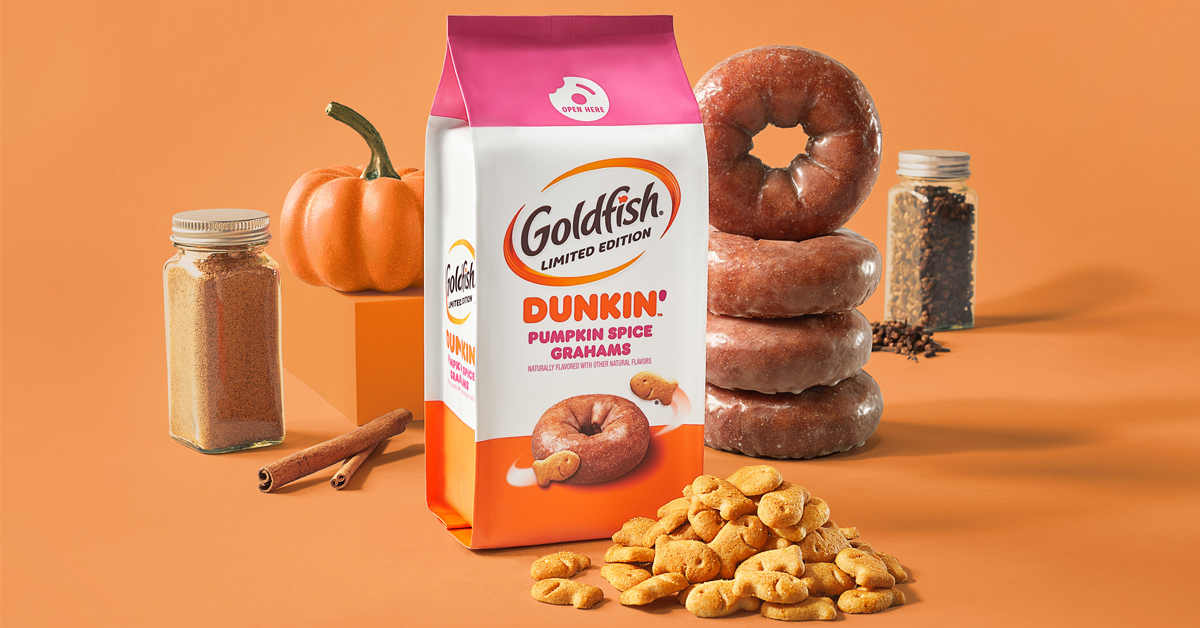 Goldfish Dunkin’ Pumpkin Spice Grahams surrounded by a pumpkin, cinnamon sticks, doughnuts and Goldfish crackers