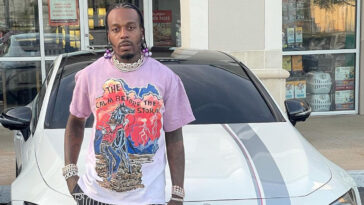 Sauce Walka stading in fron of a white luxury car