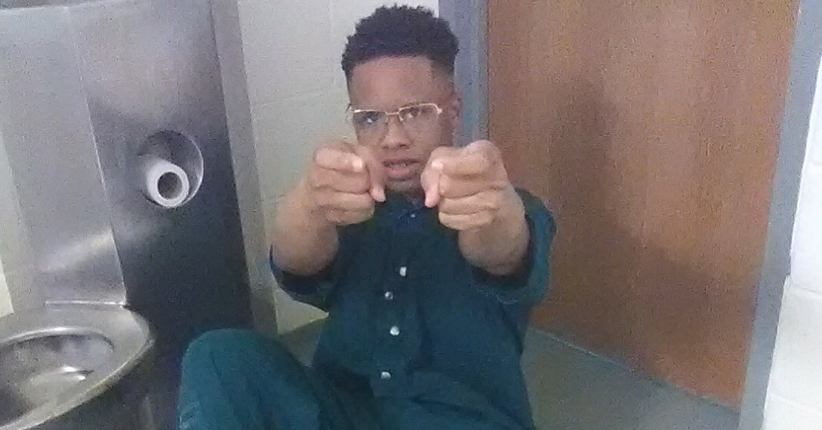 Tay-K sitting on bathroom floor