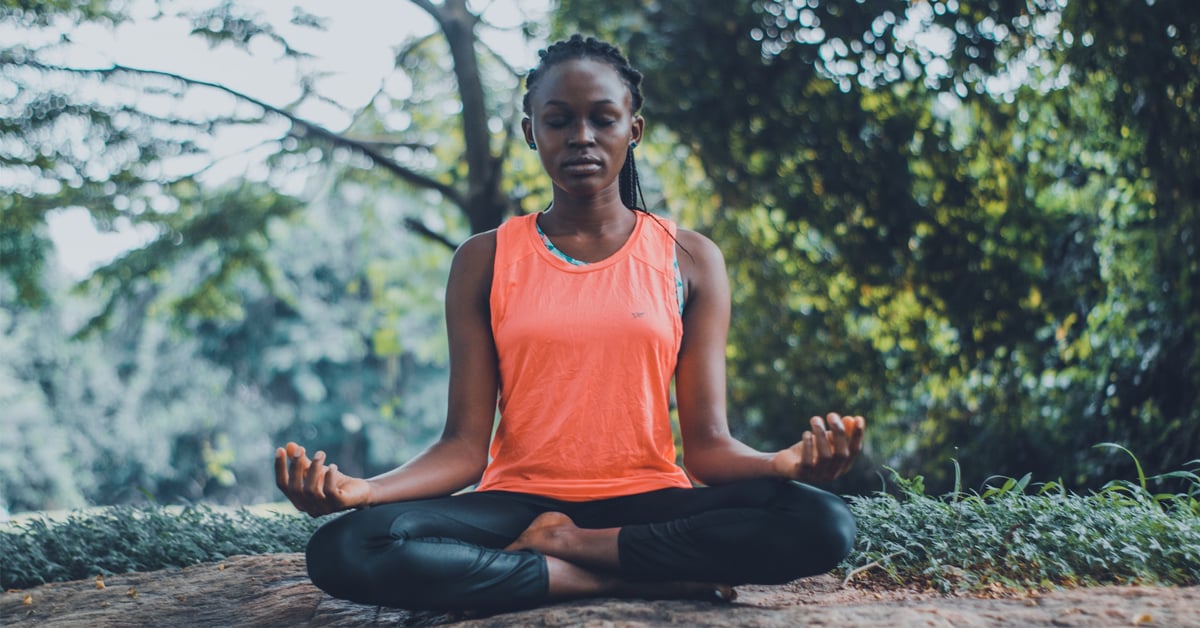 Woman meditating outdoors - one of the ways to keep one's mental well-being healthy and strong