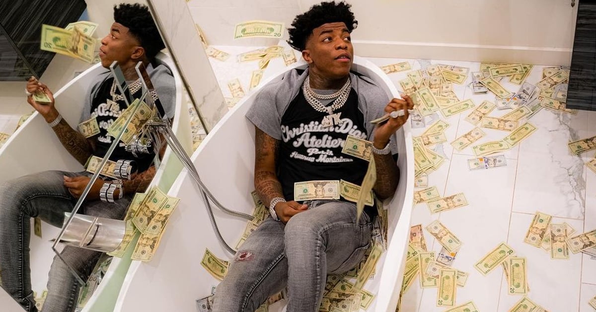 Yungeen Ace on a bath tub with filled with cash