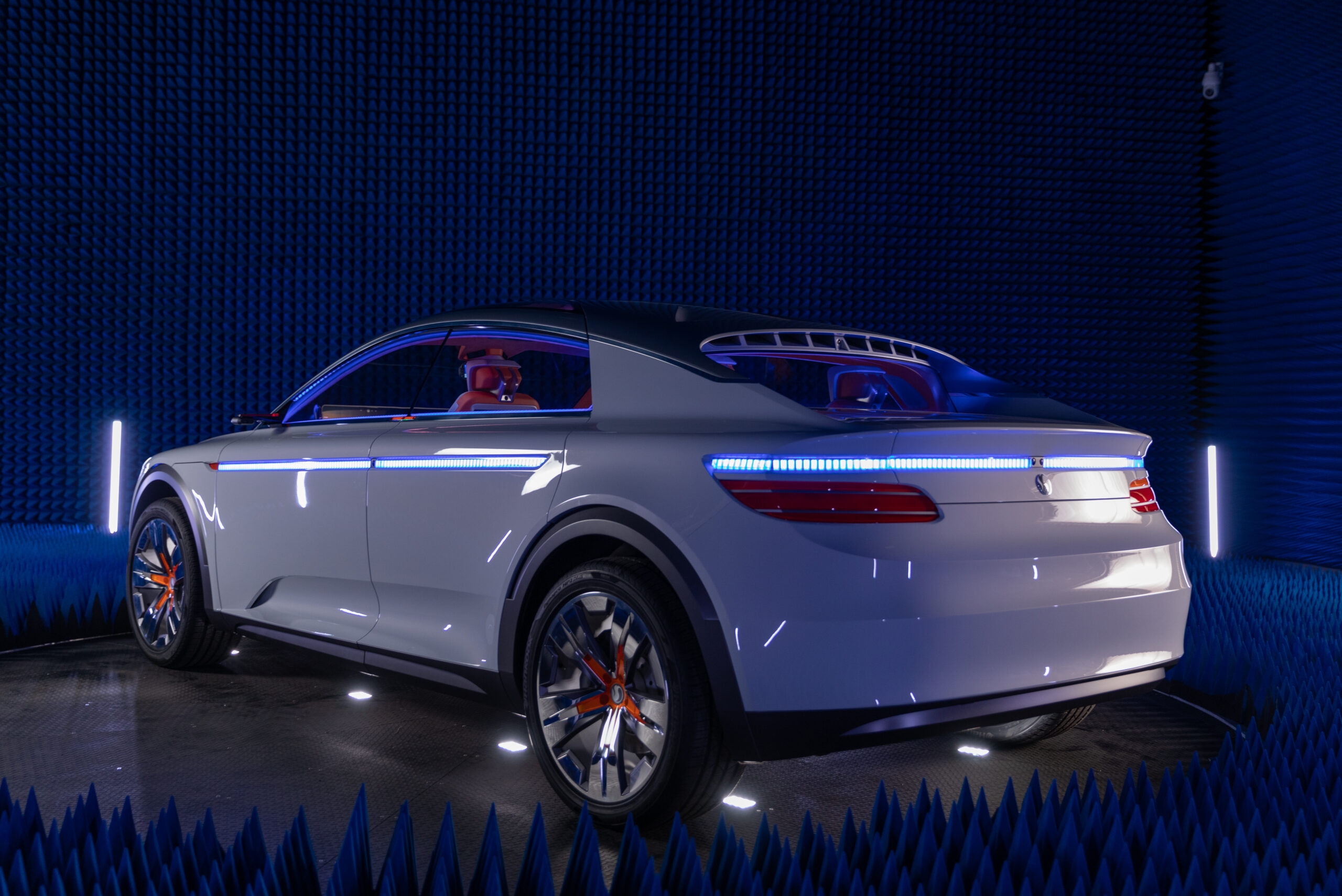 Silver concept car powered by the Qualcomm Snapdragon Ride Flex SoC on a stage
