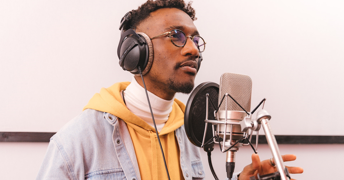 A voice acting actor inside a recording booth