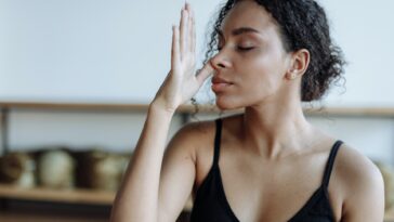 Woman in Black Tank Top Meditating