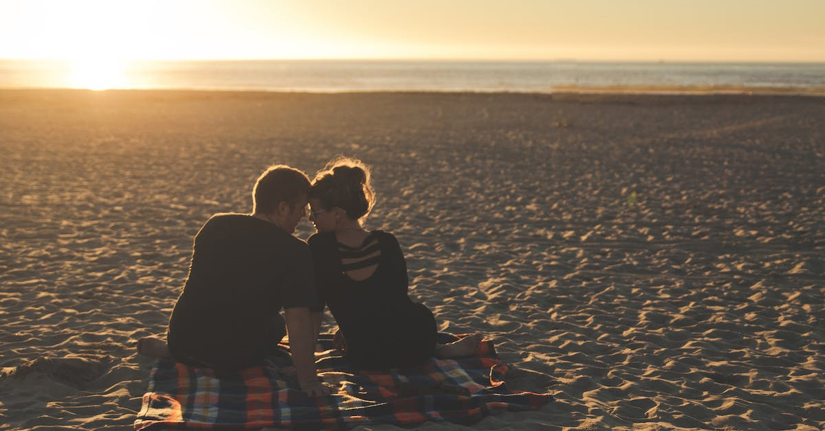 Man and woman dating by the beach