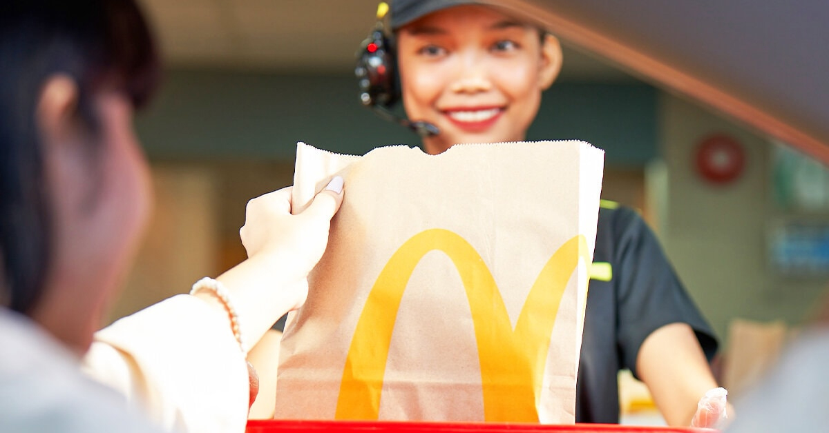 Customer getting her order at a McDonald's drive-thru. The fast-food giant reverts back to traditional drive-thru ordering after a test run of AI drive-thru.