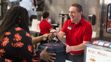 A Chick-fil-A staff member donates surplus food to local charitable organizations