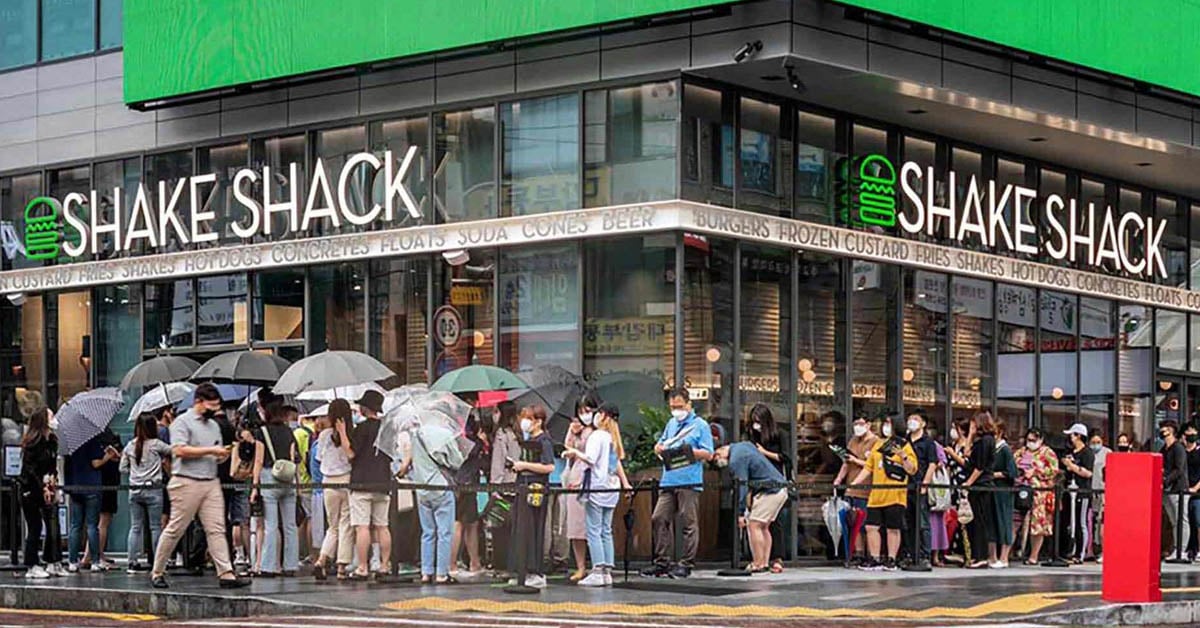 Long lines outside a Shake Shack restaurant