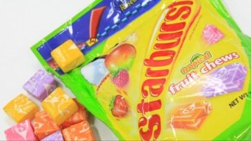 A pack of Starburst with some pieces on the side | ©Image Credit: Flickr / Toshimasa Ishibashi
