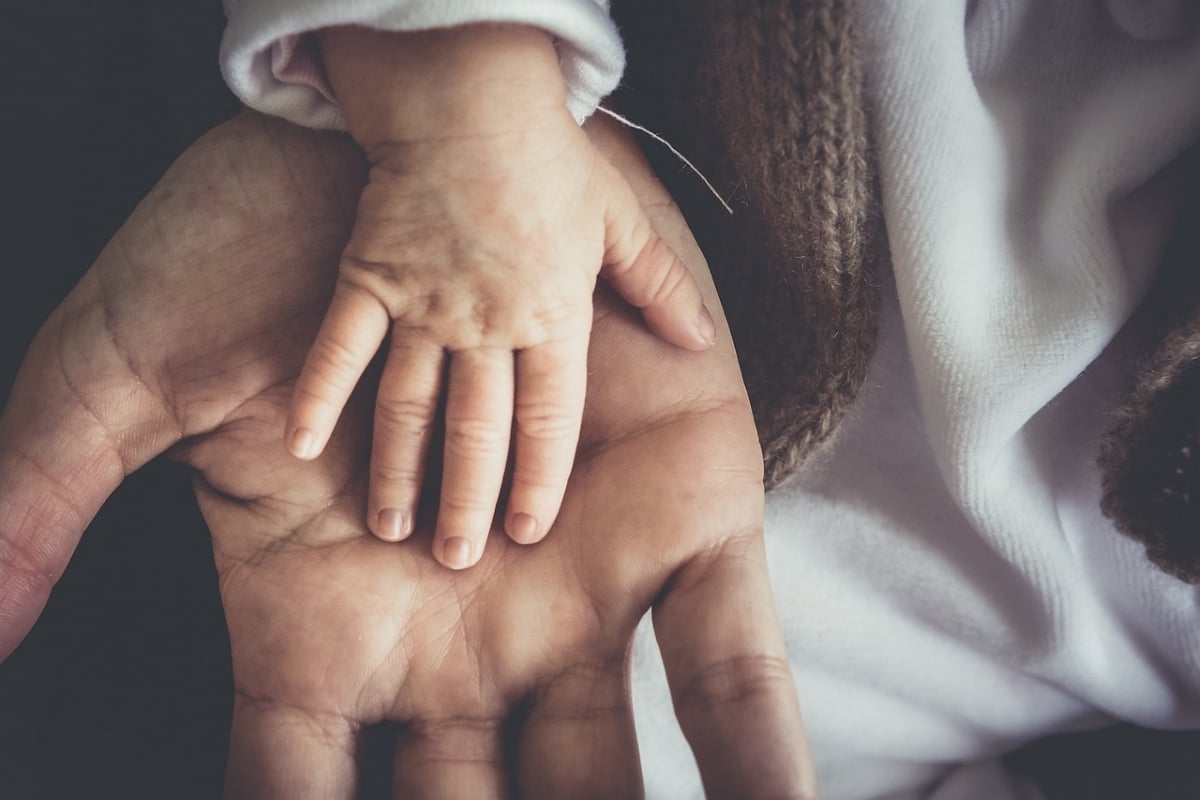 A child's hand resting on top of an adult's open palm | ©Image Credit: Pixabay / skalekar1992
