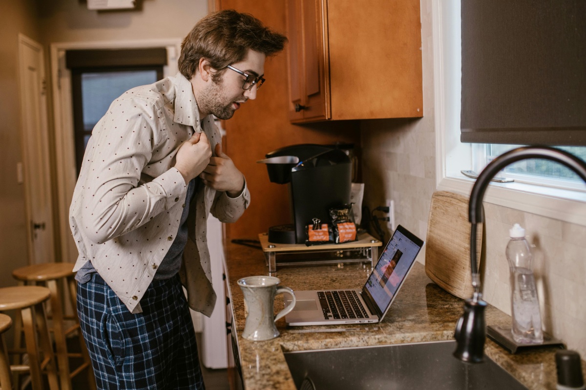 A Man Buttoning His Shirt Near a Sink | ©Image Credit: Pexels / RDNE Stock