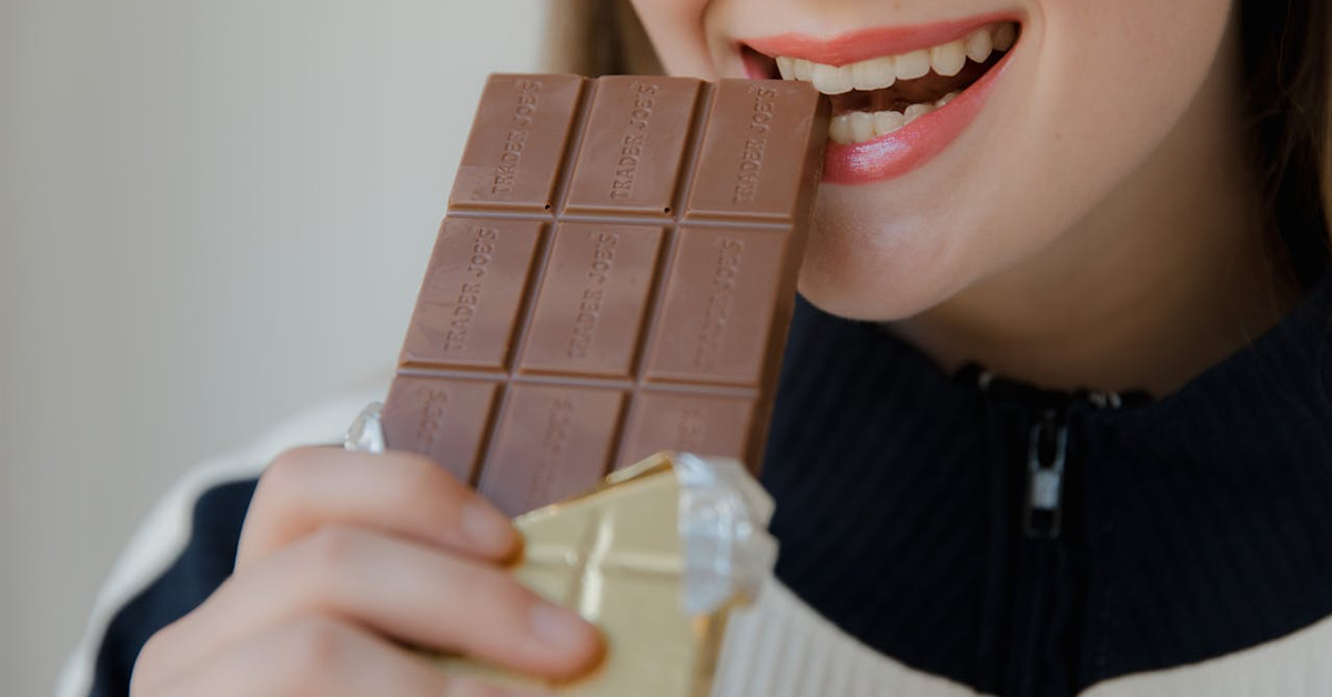 Woman biting a chocolate bar | RDNE Stock Project ©Image Credit: Pexels