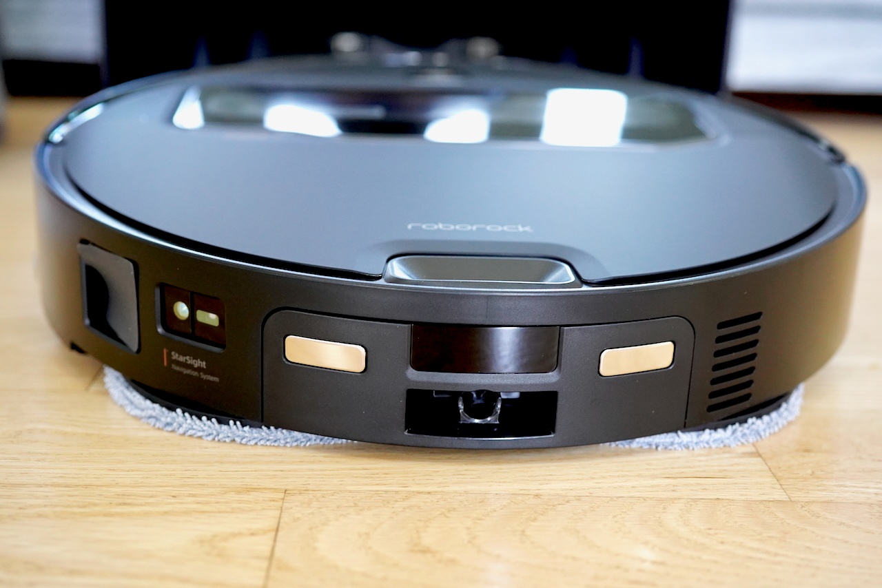  Front view of Roborock Saros Z70 robot vacuum showing sleek black design, control buttons, StarSight sensors, and low-profile build with mop pad attachment