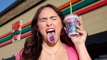 A 7-Eleven fan shows off her Tounge-too while holding a cup of small Slurpee | ©Image Credit: 7-Eleven