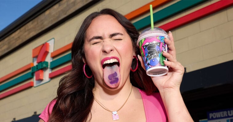 A 7-Eleven fan shows off her Tounge-too while holding a cup of small Slurpee | ©Image Credit: 7-Eleven