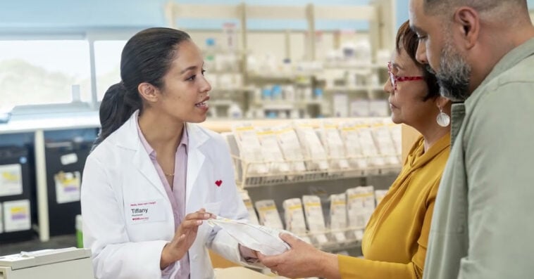 A CVS pharmacist explains prescription details to patients as the company faces a $290M Medicare fraud penalty | ©Image Credit: CVS