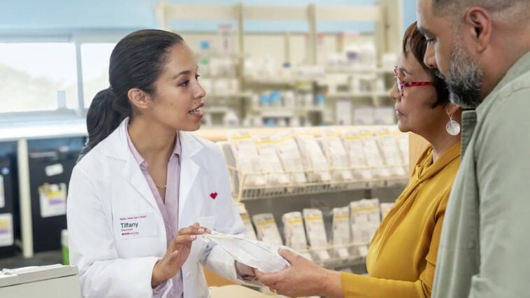 A CVS pharmacist explains prescription details to patients as the company faces a $290M Medicare fraud penalty | ©Image Credit: CVS