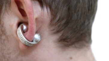 Close-up of Moto Buds Loop worn in ear showing crystal-adorned loop design
