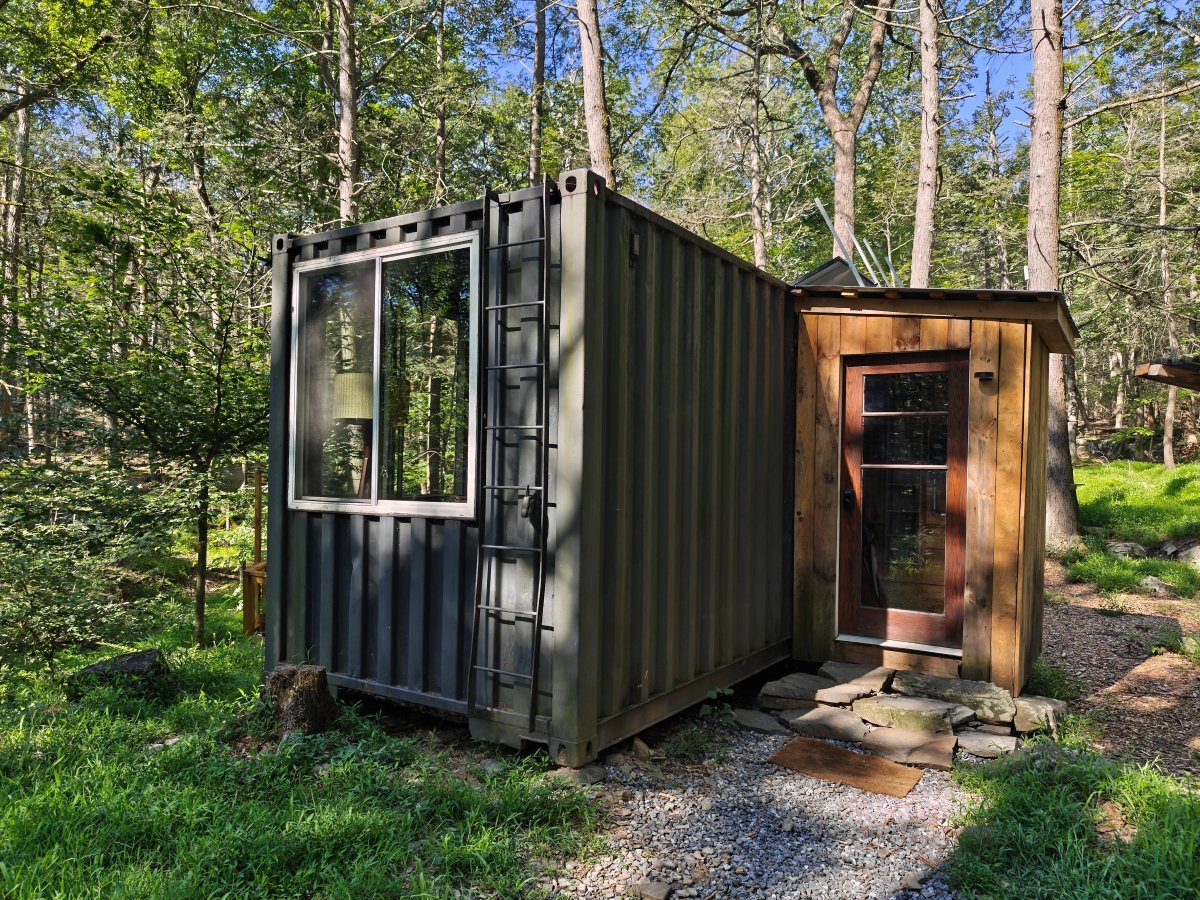 Photo sample from Nothing Phone 3 showing forest container house with rich detail