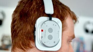 Profile view of Nothing headphones being worn, showing the fit and ergonomic design