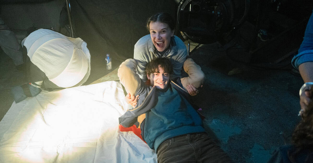 Millie Bobby Brown and Noah Schnapp share a playful moment behind the scenes of One Last Adventure: The Making of Stranger Things 5 | ©Image Credit: Atsushi Nishijima/Netflix