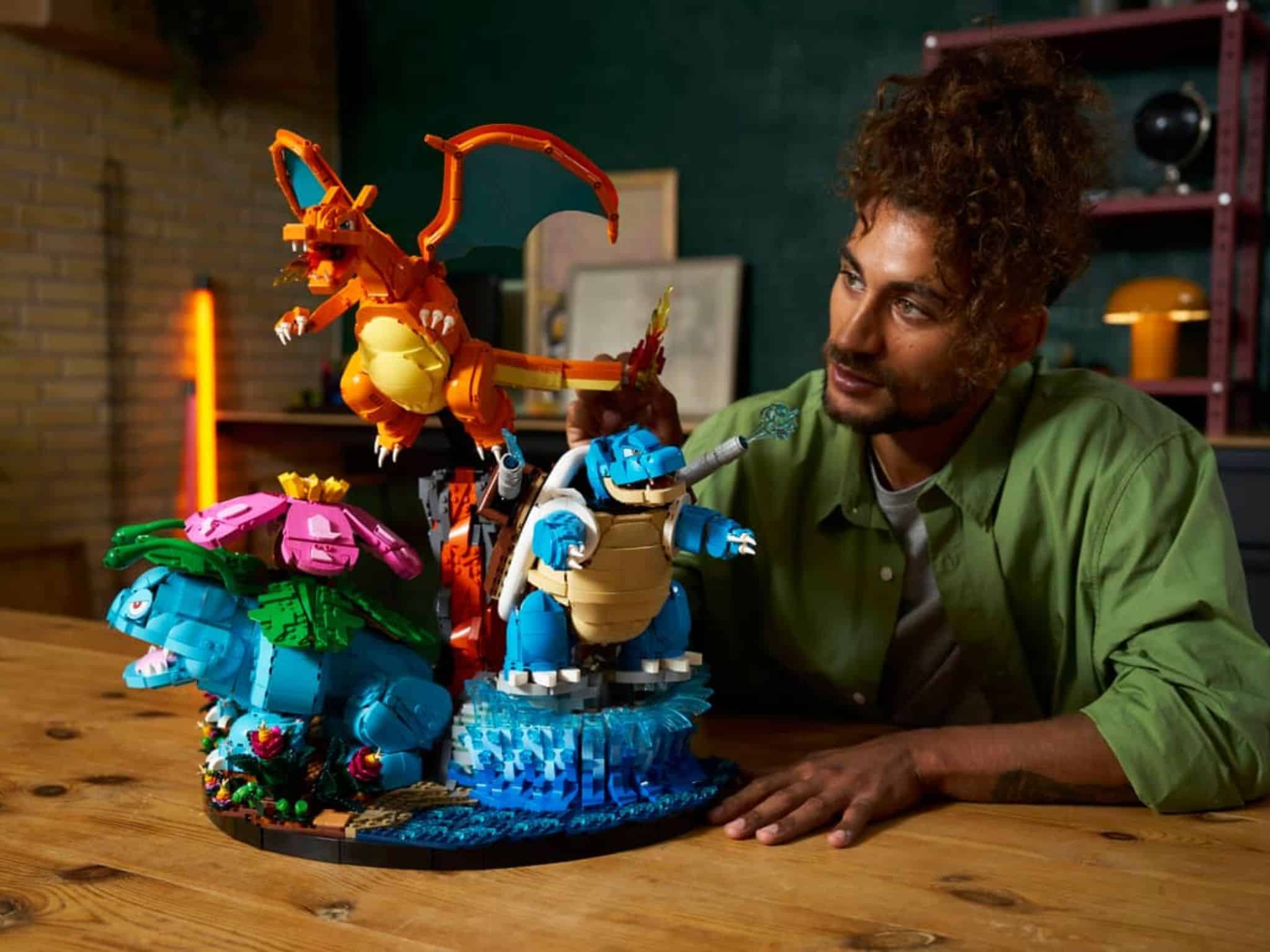 Human observing LEGO x Pokémon Venusaur, Charizard and Blastoise Set ©Image Credit: LEGO