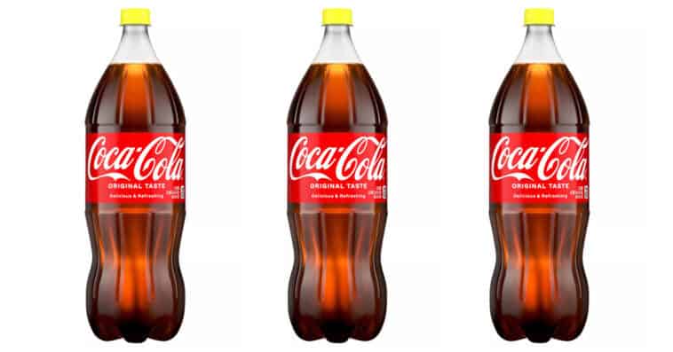 Behind the bright lid lies a 1935 secret. These yellow caps in Coca-Cola bottles represent a rich religious history and a crisp, nostalgic sugar taste. | ©Image Credit: Coca-Cola