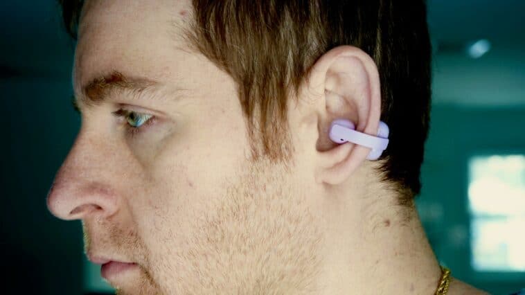 Sony Linkbuds Clip review: the open-ear trend finds its premium form 3 Side profile of a person wearing the Sony LinkBuds Clip in lavender, showing how the earbud clips onto the outer ear without any insertion
