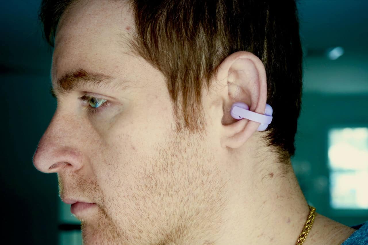 Sony Linkbuds Clip review: the open-ear trend finds its premium form 8 Side profile of a person wearing the Sony LinkBuds Clip in lavender, showing how the earbud clips onto the outer ear without any insertion