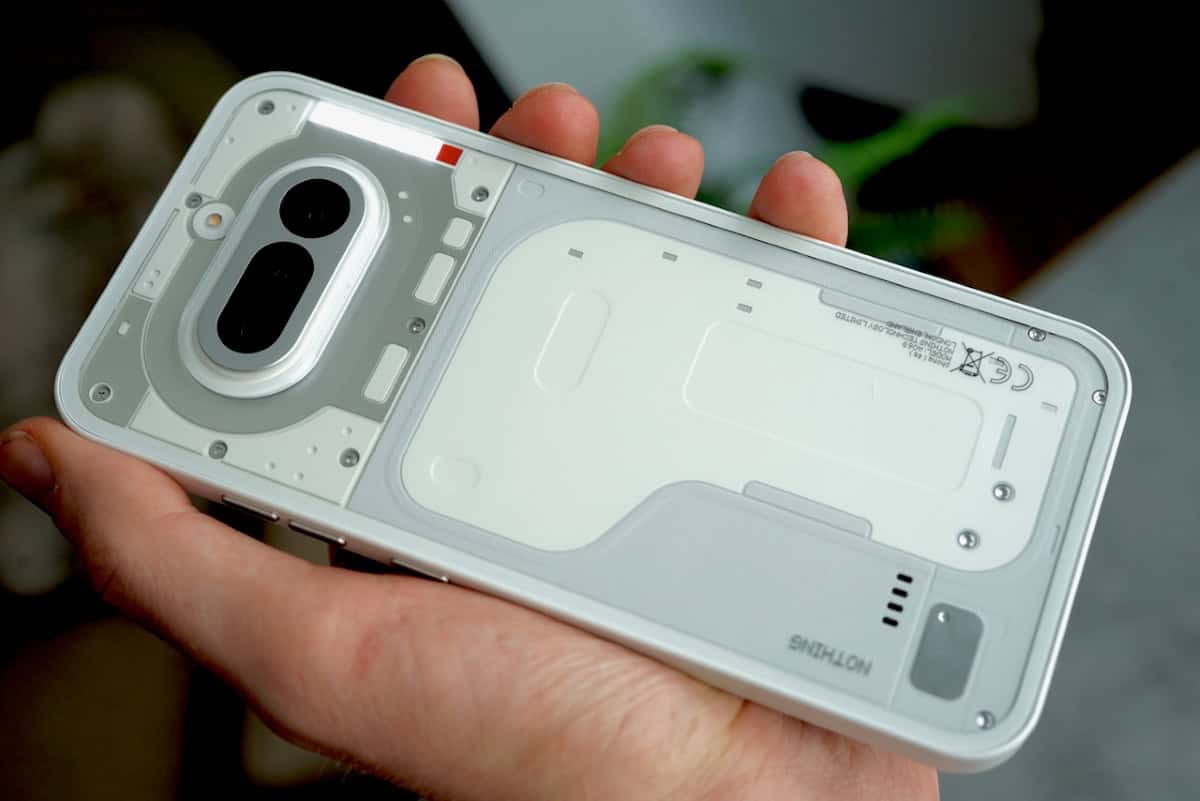 Close-up of the back of the white Nothing Phone (4a) highlighting the transparent design and Glyph lighting strips.