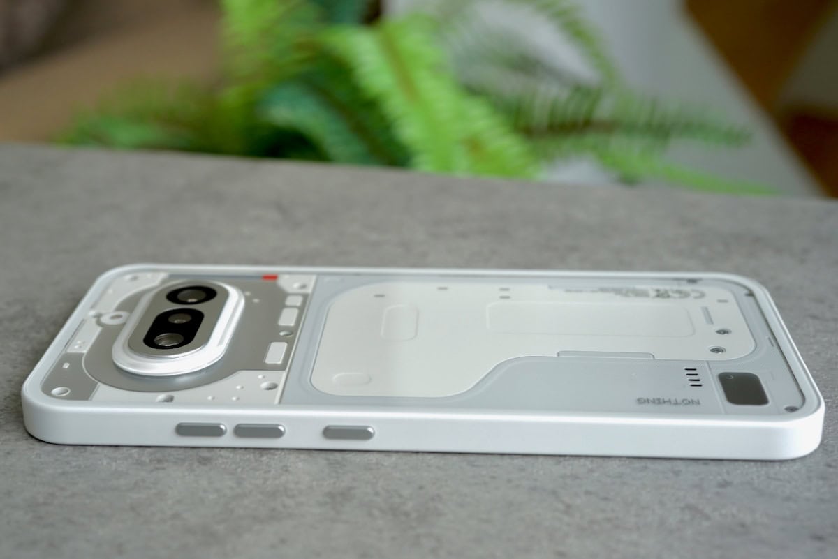 Side view of the Nothing Phone (4a) showing the matte white frame and silver power and volume buttons.