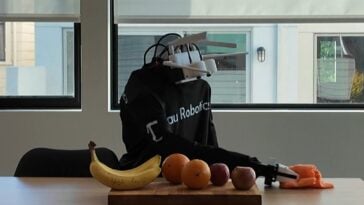 A Tau Robotics humanoid robot demonstrates surface cleaning in a company demo | ©Image Credit: Tau Robotics
