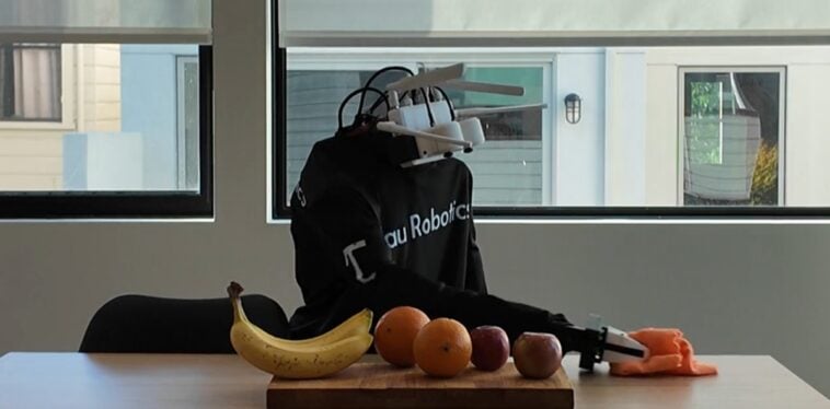 A Tau Robotics humanoid robot demonstrates surface cleaning in a company demo | ©Image Credit: Tau Robotics
