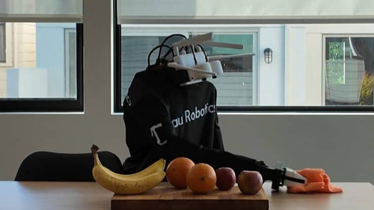 A Tau Robotics humanoid robot demonstrates surface cleaning in a company demo | ©Image Credit: Tau Robotics