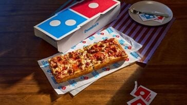 Domino’s, the world’s largest pizza company, is finally launching a menu item named after itself: The Domino. ©Image Credit: Domino’s