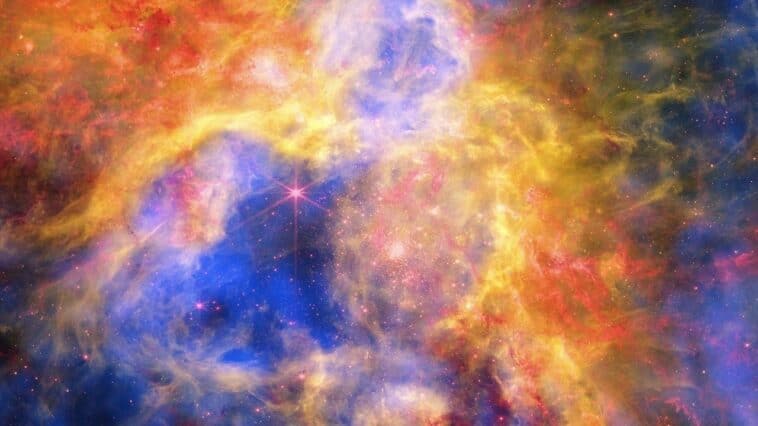 NASA layered X-ray, infrared, and optical light from 3 giant observatories to bring us this stunning view of the Tarantula Nebula . ©Image Credit: NASA