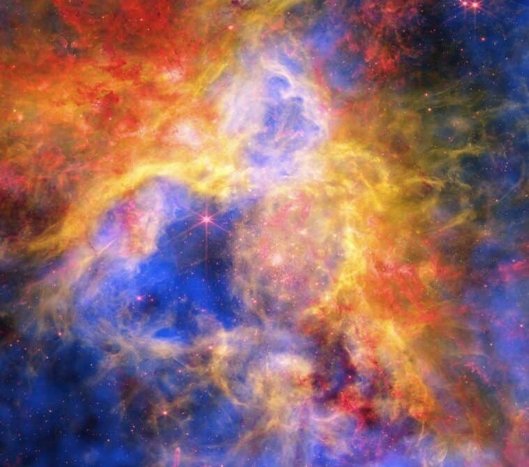 NASA layered X-ray, infrared, and optical light from 3 giant observatories to bring us this stunning view of the Tarantula Nebula . ©Image Credit: NASA