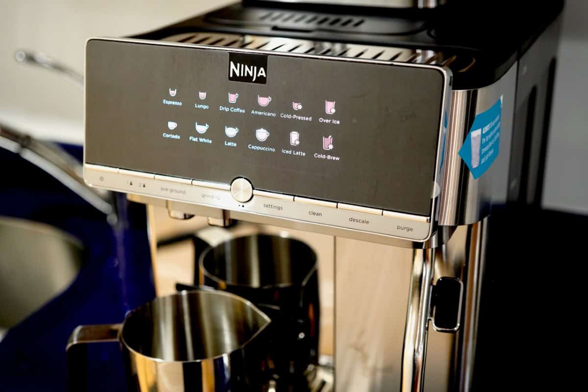 Close-up of the Ninja AutoBarista Pro illuminated display panel showing various coffee drink icons and settings