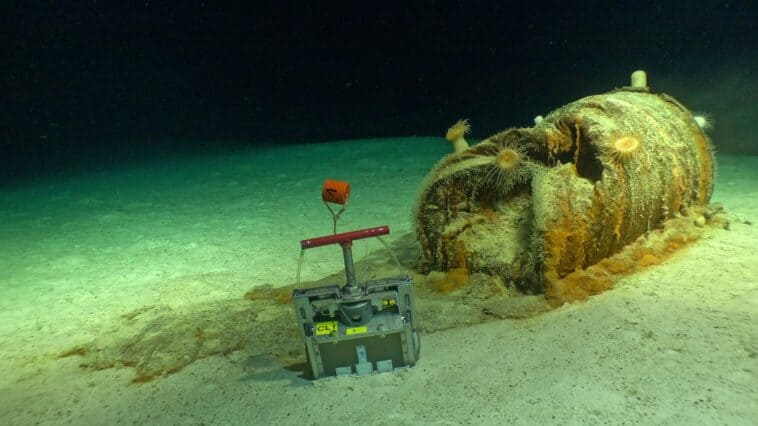 Scientists find 200,000 barrels of radioactive waste in the ocean 1 A heavily corroded radioactive waste barrel leaks onto the seafloor as a Nautile sampling device collects sediment at 4,700 metres during the 2026 NODSSUM expedition | ©Image Credit: Campagne NODSSUM, CNRS, Flotte océanographique française