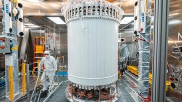 Suspended inside a mile-deep water tank, the LUX-ZEPLIN experiment uses 10 tonnes of liquid xenon to detect the ultra-faint flashes of light emitted when a dark matter particle hits a xenon nucleus. ©Image Credit: Matthew Kapust / Sanford Underground Research Facility