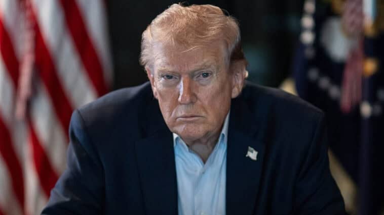 Trump dismisses warnings about AI risks as a “hoax” while tech leaders call for stronger guardrails and lawmakers debate new safeguards. | ©Image Credit: Donald J. Trump / Facebook