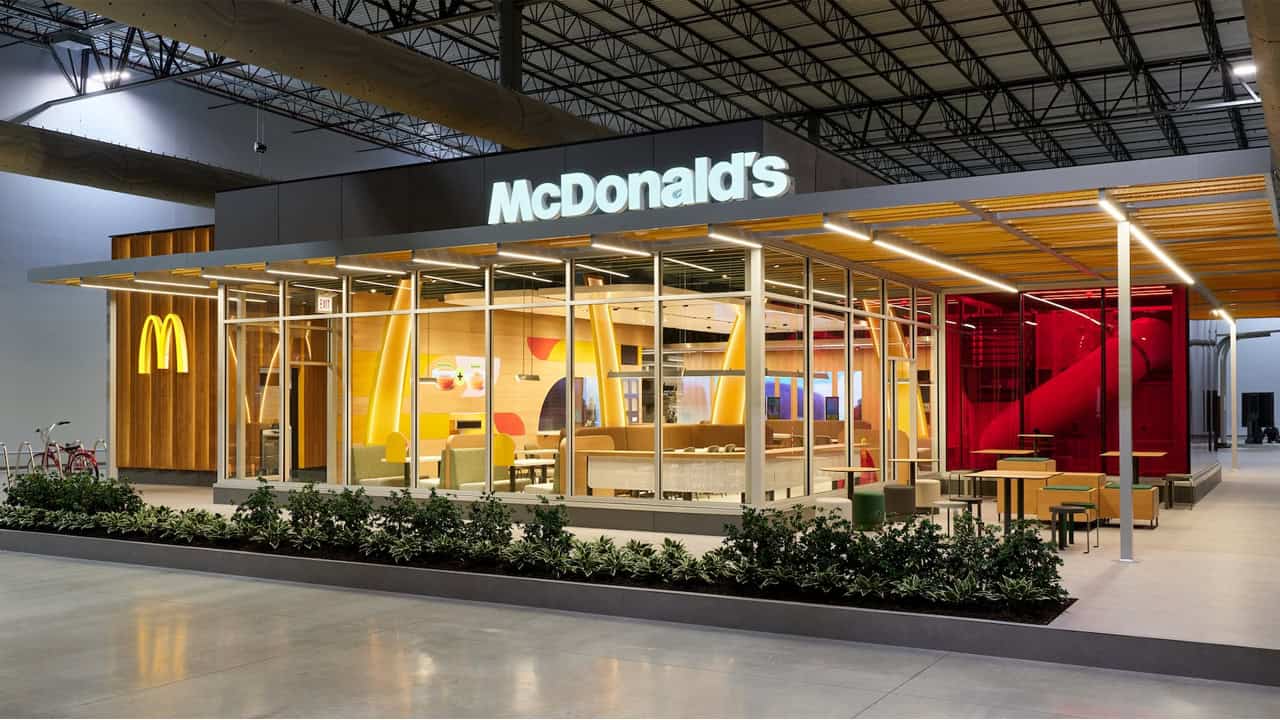 The exterior of a remodeled McDonald’s restaurant, featuring modern lighting and expanded dining spaces for customers. | ©Image Credit: McDonald's