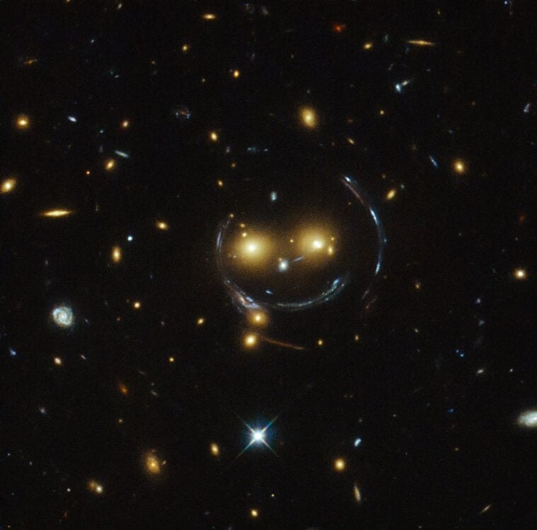 NASA reveals stunning image of giant cosmic smile 1 Captured by the Hubble Space Telescope, galaxy cluster SDSS J1038+4849 creates a giant cosmic smiley face through the physics of gravitational lensing. ©Image Credit: NASA