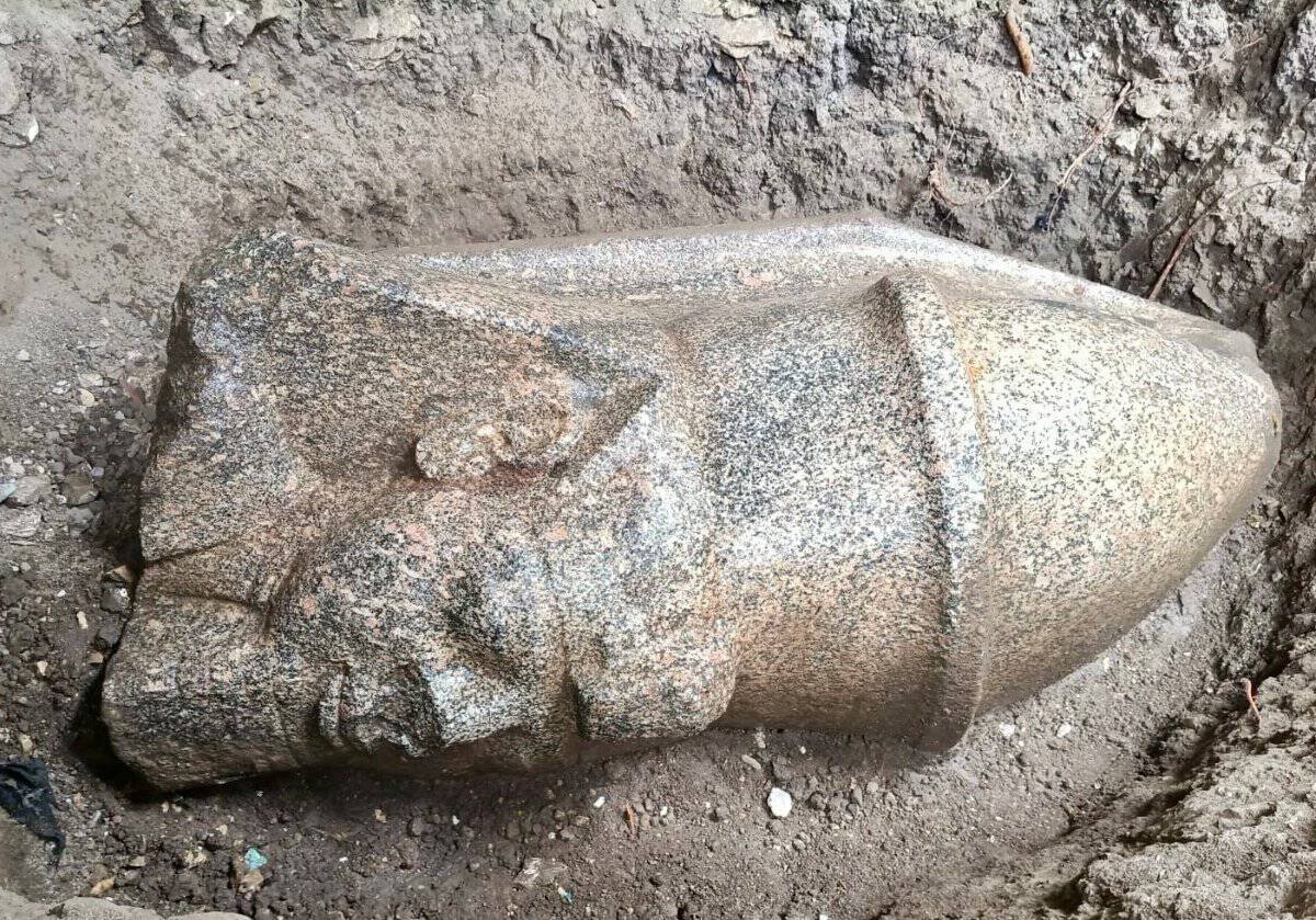 The newly discovered red-granite head of King Ramses II at the excavation site in Gharbia province | ©Image Credit: Ministry of Tourism and Antiquities (Egypt)
