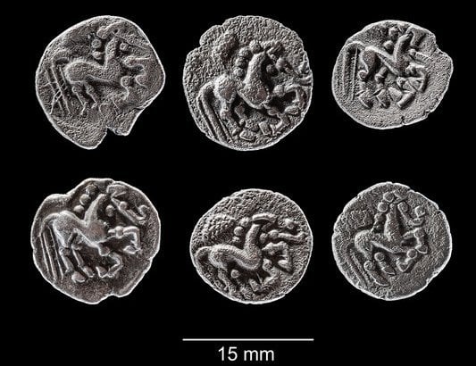 Archaeologists find 2,000 year old treasure under sports field 1 Six of the 11 Celtic silver coins (Prague-type quinarii) dating to the first century B.C., unearthed in Singen, Germany | ©Image Credit: TLDA (Thüringisches Landesamt für Denkmalpflege und Archäologie) / CC BY-NC-ND 4.0